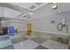Spacious three car garage features black and gray tiled floors, storage shelves and cabinetry at 104 San Sophia Dr, Chapel Hill, NC 27514
