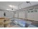 Large three car garage with painted walls and ceiling, and epoxy diamond pattern flooring at 104 San Sophia Dr, Chapel Hill, NC 27514