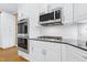 Kitchen with white cabinets, stainless steel appliances and subway tile backsplash at 104 San Sophia Dr, Chapel Hill, NC 27514