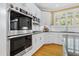 Kitchen features stainless steel appliances, white cabinets, hardwood floors and lots of natural light at 104 San Sophia Dr, Chapel Hill, NC 27514