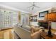 Cozy living room with fireplace, built-in shelving, and doors to the porch at 104 San Sophia Dr, Chapel Hill, NC 27514