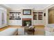 Living room with a fireplace, built-in shelving, and hardwood flooring at 104 San Sophia Dr, Chapel Hill, NC 27514