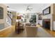 Bright living room boasts hardwood floors, fireplace, and seamless access to a screened porch at 104 San Sophia Dr, Chapel Hill, NC 27514
