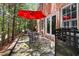Flagstone patio with red umbrella, iron chairs and table overlooking wooded backyard at 104 San Sophia Dr, Chapel Hill, NC 27514