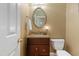 Well-lit powder room with oval mirror, granite countertop, and neutral wall color at 104 San Sophia Dr, Chapel Hill, NC 27514