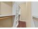 Spacious walk-in closet featuring built-in shelving and hanging rods for ample storage at 104 San Sophia Dr, Chapel Hill, NC 27514