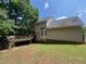 Back view of a two-story home featuring a spacious wooden deck and siding at 109 Hidden Farm Ln, Holly Springs, NC 27540
