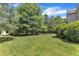 Secluded backyard with mature trees, spacious lawn and outbuilding offers a private retreat at 1123 Poplar Forest Ln, Pittsboro, NC 27312