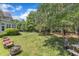 Backyard with mature trees, outdoor seating, and a fire pit perfect for entertaining at 1123 Poplar Forest Ln, Pittsboro, NC 27312