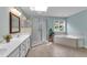 Bright bathroom with double vanity, glass shower, and soaking tub at 1123 Poplar Forest Ln, Pittsboro, NC 27312