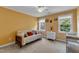 Inviting bedroom with carpet, natural light, and comfortable furniture, perfect for relaxing and enjoying the view at 1123 Poplar Forest Ln, Pittsboro, NC 27312