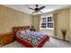 Comfortable bedroom featuring a ceiling fan, large window, and neutral walls, creating a relaxing atmosphere at 1123 Poplar Forest Ln, Pittsboro, NC 27312