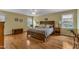 Comfortable bedroom with hardwood floors, ceiling fan, and natural light at 1123 Poplar Forest Ln, Pittsboro, NC 27312