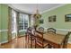 Dining room with a wooden table, chandelier, and large window offering natural light at 1123 Poplar Forest Ln, Pittsboro, NC 27312
