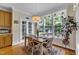 Charming dining area with a large window, wooden table, and decorative light fixture at 1123 Poplar Forest Ln, Pittsboro, NC 27312