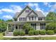 Charming two-story home featuring black shutters, a covered front porch and manicured landscaping at 1123 Poplar Forest Ln, Pittsboro, NC 27312
