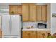 Kitchen featuring wooden cabinets, white appliances, and plenty of counter space at 1123 Poplar Forest Ln, Pittsboro, NC 27312