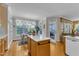Bright kitchen with an island, white countertops, hardwood floors, and natural light at 1123 Poplar Forest Ln, Pittsboro, NC 27312