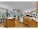 Open-concept kitchen and living area with stainless steel appliances, hardwood floors, and natural light at 1123 Poplar Forest Ln, Pittsboro, NC 27312