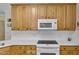 Kitchen with white countertops, wooden cabinets, and modern appliances, microwave, and stove at 1123 Poplar Forest Ln, Pittsboro, NC 27312