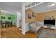 Cozy living room with wood floors, comfortable seating, and view into dining room at 1123 Poplar Forest Ln, Pittsboro, NC 27312