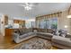 Cozy living room area with large sectional sofa, hardwood floors, and an open view into the kitchen at 1123 Poplar Forest Ln, Pittsboro, NC 27312