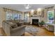 Comfortable living room featuring a fireplace, large windows, and a plush sectional sofa at 1123 Poplar Forest Ln, Pittsboro, NC 27312