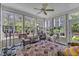 Bright sunroom with tile floor, multiple windows with a lovely view, and ceiling fan for comfortable living at 1123 Poplar Forest Ln, Pittsboro, NC 27312