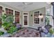 Cozy sunroom featuring large windows, a ceiling fan, and comfortable wicker furniture for relaxing and enjoying the view at 1123 Poplar Forest Ln, Pittsboro, NC 27312