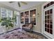 Relaxing sunroom with tile floors, multiple windows, and comfortable wicker seating at 1123 Poplar Forest Ln, Pittsboro, NC 27312