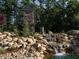 Waterfall feature at entrance to community with stone architecture and landscaping at 115 Evington Dr # 29, Pittsboro, NC 27312