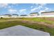 Backyard with white picket fence bordering the homes, and sparse grass at 1204 Bridgewater Dr, Durham, NC 27704