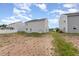 A spacious backyard with patchy grass, leading up to the house at 1204 Bridgewater Dr, Durham, NC 27704