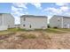 An exterior shot of a backyard, mostly bare dirt with limited grass and foliage at 1204 Bridgewater Dr, Durham, NC 27704