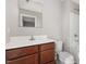 Bathroom featuring a white countertop, wooden cabinets, and a shower-tub combo at 1204 Bridgewater Dr, Durham, NC 27704