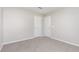 Neutral bedroom with two white doors and soft gray carpeting and walls at 1204 Bridgewater Dr, Durham, NC 27704