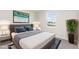 Staged bedroom with bed, lamps, bedside tables and potted plant at 1204 Bridgewater Dr, Durham, NC 27704