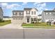 Two-story home featuring a two-car garage and neutral-colored siding, complemented by well-maintained landscaping at 1204 Bridgewater Dr, Durham, NC 27704
