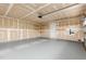 Unfinished garage with shelves, a back door, and visible drywall seams at 1204 Bridgewater Dr, Durham, NC 27704