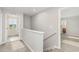Upstairs hallway with carpeting leads to bedrooms and a bathroom, providing comfortable passage at 1204 Bridgewater Dr, Durham, NC 27704
