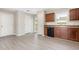 Bright kitchen features wood cabinets, gray floors, a window, and stainless steel appliances at 1204 Bridgewater Dr, Durham, NC 27704