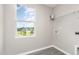 Bright laundry room with a window view and a wire storage rack at 1204 Bridgewater Dr, Durham, NC 27704