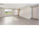 Open-plan living room with wood look floors, and lots of natural light from a large window at 1204 Bridgewater Dr, Durham, NC 27704
