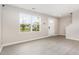 Bright, neutral living room showcasing large window views, wood look floors and ample space at 1204 Bridgewater Dr, Durham, NC 27704