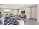 Bright living room featuring modern furniture and a stylish blue rug at 1204 Bridgewater Dr, Durham, NC 27704