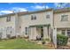 A lovely home backyard showcasing a covered patio, small garden, and lush green grass at 12227 Orchardgrass Ln, Raleigh, NC 27614