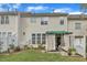 A lovely home backyard showcasing a covered patio, small garden, and lush green grass at 12227 Orchardgrass Ln, Raleigh, NC 27614