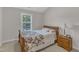Inviting bedroom featuring a bed with decorative quilt, and a bedside table with a lamp at 12227 Orchardgrass Ln, Raleigh, NC 27614