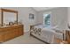 Comfortable bedroom with a traditional wooden bed frame, bedside table, and a chest of drawers at 12227 Orchardgrass Ln, Raleigh, NC 27614
