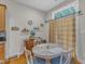 Bright dining area with a round table, wooden chairs, and a charming, sunny window at 12227 Orchardgrass Ln, Raleigh, NC 27614